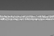 SEM image of the full Li-NMC electrode sample, showing the two porous layers and the metal film at the center of the structure.