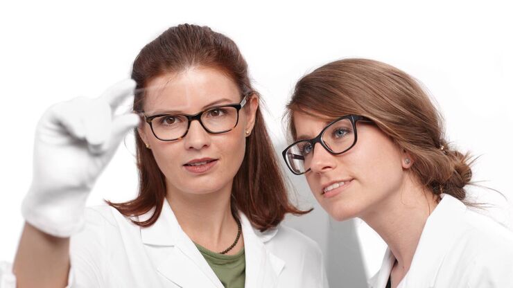 Two women looking at a sample