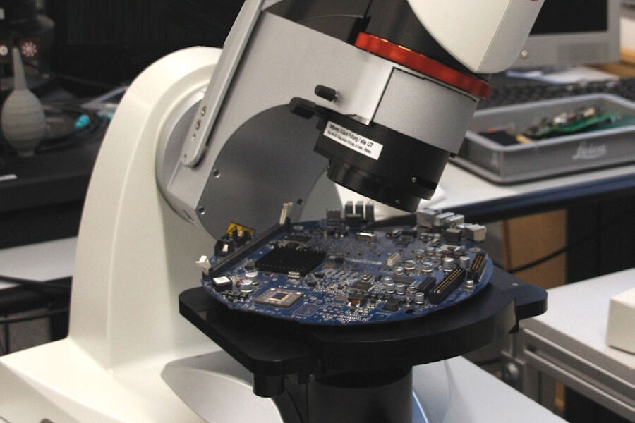 DVM6 digital microscope with a PCBA sample on the stage.