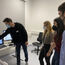 Elisa Holstein, Simone Clas, and Dario Frey (from left to right, all DKFZ, Heidelberg) learning about laser microdissection from Christoph Greb (left, Leica Microsystems) at the LMD7.