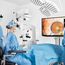 Surgical team collaborating during a cataract surgery using MyVeo 3D surgical headsets, with one team member viewing the procedure on a 3D monitor