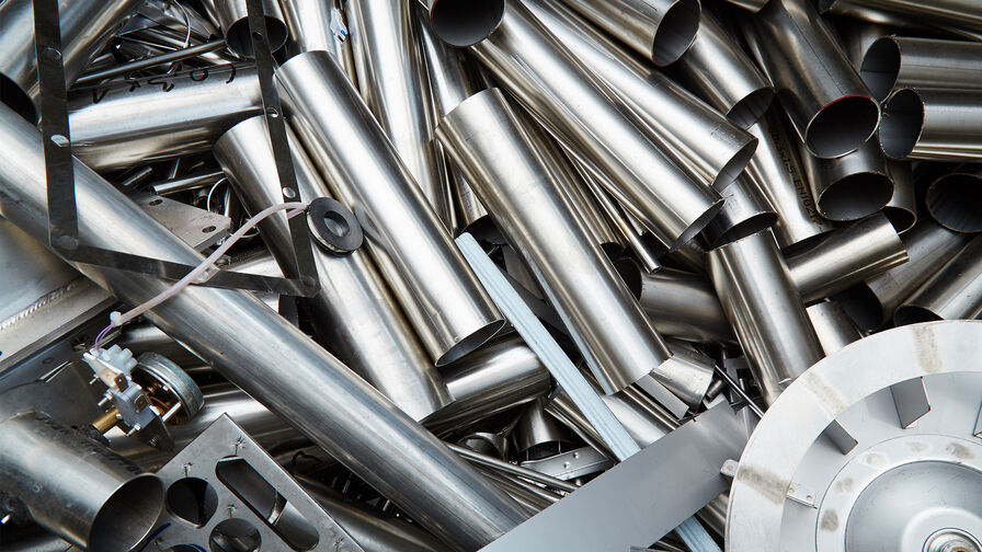 Photo of steel scrap including stainless steel pipes and other parts.