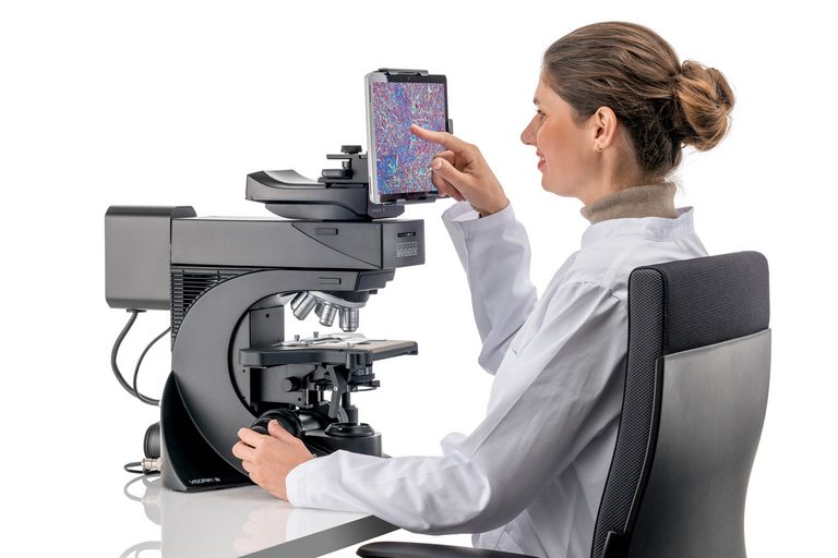 User operating the Visoria B digital laboratory microscope.