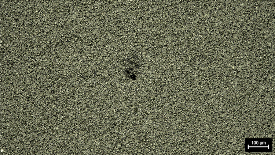 Battery electrode showing a hole defect. Image acquired with darkfield illumination and a Leica compound microscope.