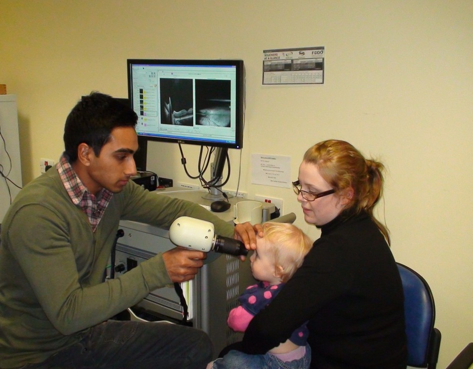 Eye examination of a child using the hand-held OCT EnVisu